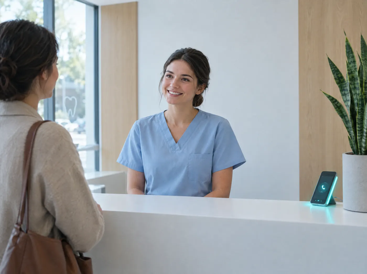 Dental receptionist with a patient while the AI answers the phone